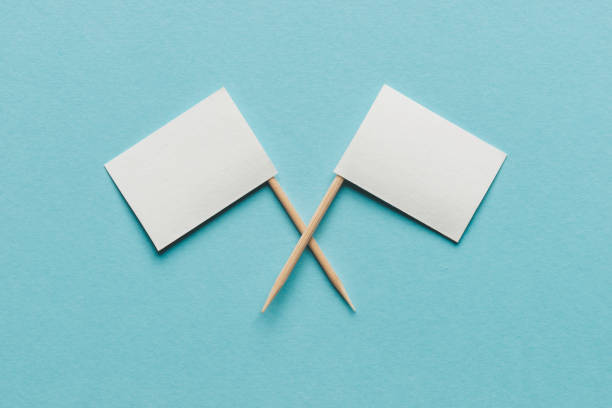 Two White Flags Two white empty flags on blue background. diplomacy stock pictures, royalty-free photos & images