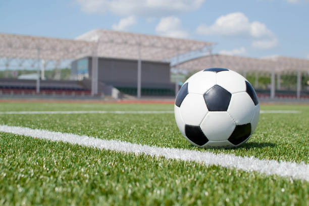 istock soccer ball on the green field 1393521959