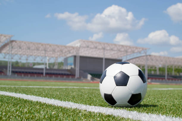 istock soccer ball on the green field 1393521967