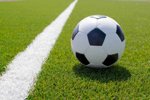 istock soccer ball on the green field 1393522573