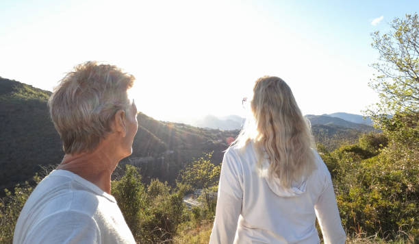 istock Mature couple hike along forested hillside 1393522709
