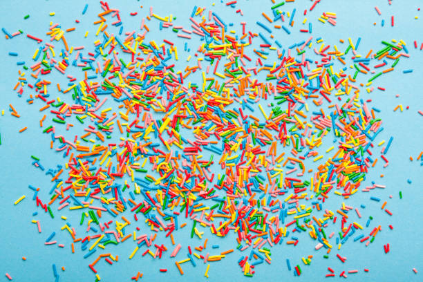 istock Colorful sweet sugar sprinkles on blue background. 1393526948