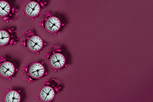 Clocks on pink background