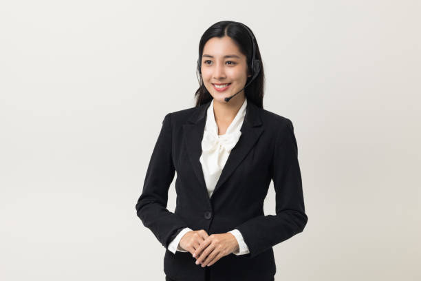 happy young asian business woman call centre. welcome female operator put on smalltalk headphone standing on isolated white background. - women customer service representative service standing imagens e fotografias de stock