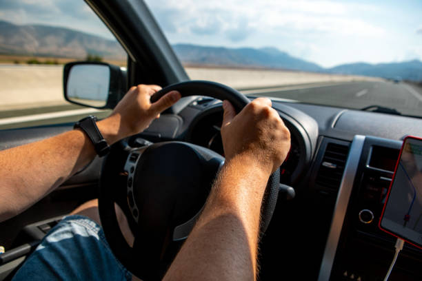 istock man hands on steering wheel car travel concept 1393530488