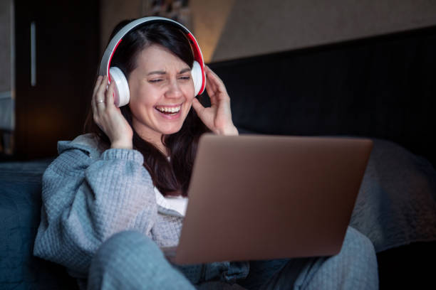 istock woman in headset working on laptop has video call 1393530956