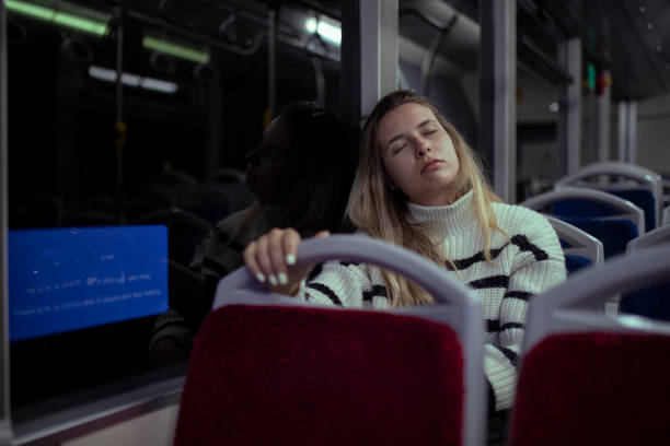 istock A tired woman resting on a bus during a night ride. 1393531829