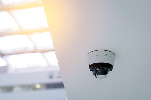 Security CCTV camera on white ceiling, Intelligent cameras, Video recording, Anti-theft system, Surveillance.
