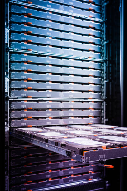 maintenance of hard drives inside data storage hosting center - open tray with cluster of hard disks waiting to be inspected