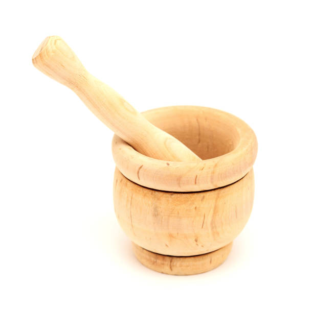 istock Small wooden mortar and pestle isolated 1393536537