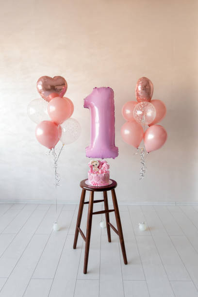 istock pink helium balloons and birthday cake 1393537328