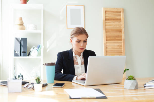 istock Young businesswoman using laptop in the workspace 1393541987