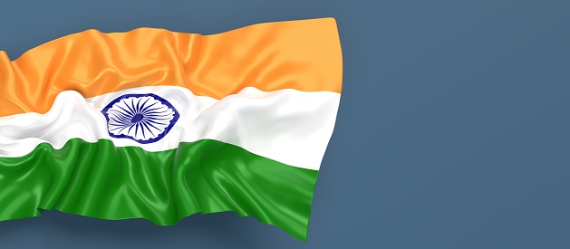 Partial Indian flag is waving on blue gray background. Horizontal composition with copy space. Easy to crop for all your social media and print sizes.
