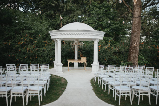 istock Beautiful setting for outdoors wedding ceremony. Wedding arch with flowers. 1393548054