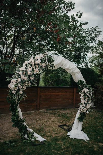 istock Beautiful setting for outdoors wedding ceremony. Wedding arch with flowers. 1393548080