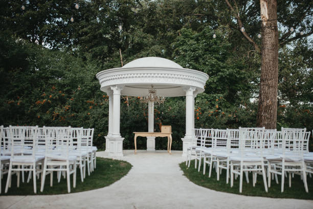 istock Beautiful setting for outdoors wedding ceremony. Wedding arch with flowers. 1393548155