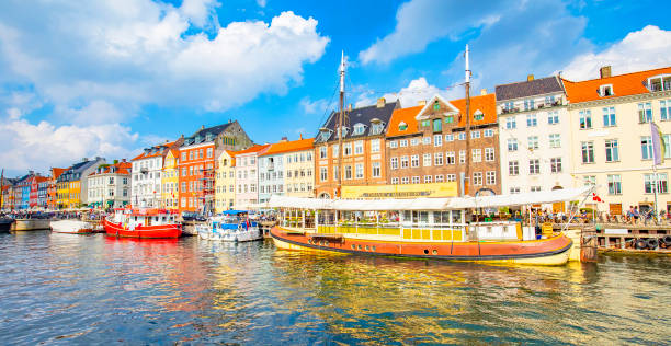 Panorama of Nyhavn harbour in Kopenhagen old town, Denmark Copenhagen, Denmark - 30 April, 2022: Nyhavn harbour and water canal in old town denish stock pictures, royalty-free photos & images