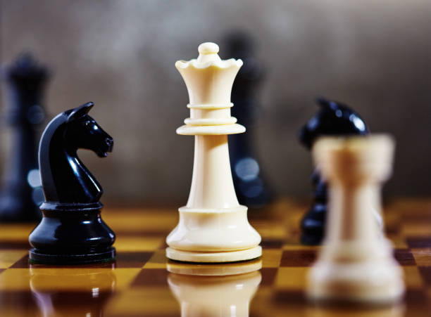 istock White queen dominates chess game, with copy space on blurred gray background 1393549290
