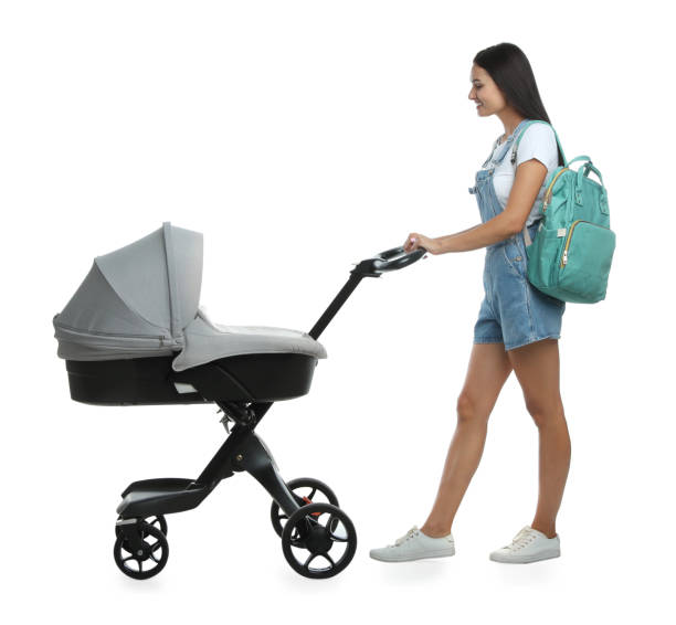 istock Happy young woman with baby stroller on white background 1393551094