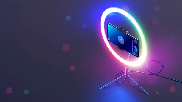 Vector illustration of Phone on RGB led ring light on tripod on table. Smartphone streams video in internet. Vlogging concept. Color smart lamp for shoot a video or selfie through camera phone in the dark on desk.