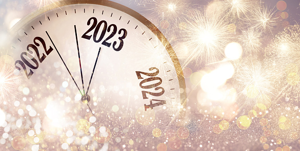 Clock counting last moments to New 2023 Year and beautiful fireworks on background, banner design