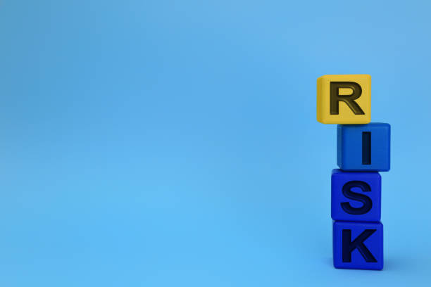 istock Stack of color wooden cubes with word Risk on light blue background. Space for text 1393555526