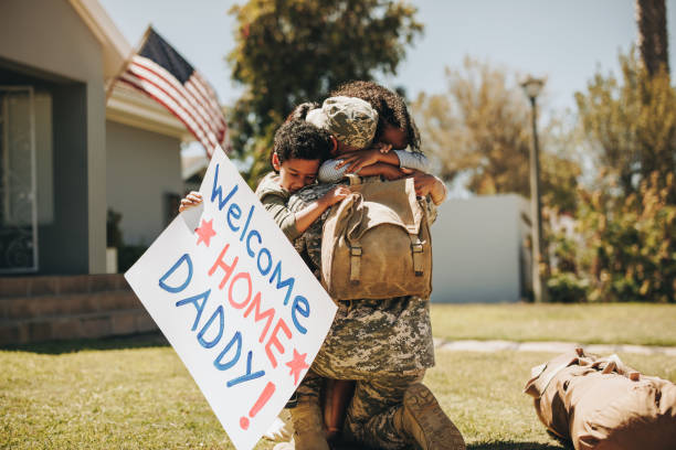istock Serviceman reuniting with his family after returning home 1393555703