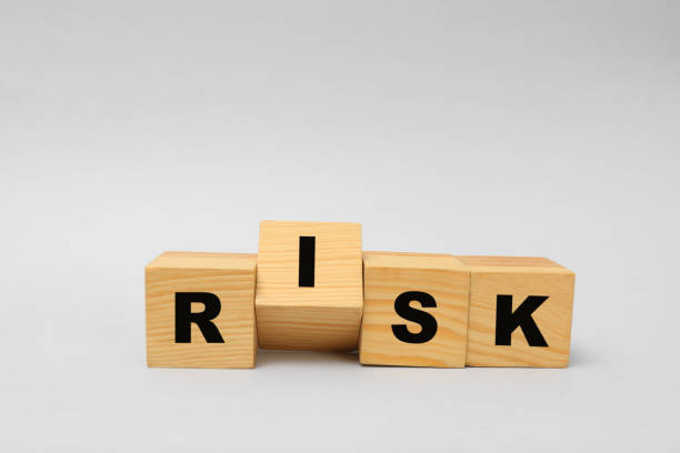 istock Wooden cubes with word Risk on light grey background 1393555840