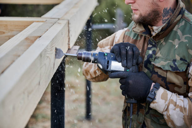 istock Man worker building wooden frame house on pile foundation. 1393555905