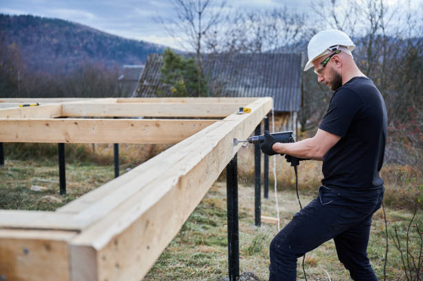 istock Man worker building wooden frame house on pile foundation. 1393555911