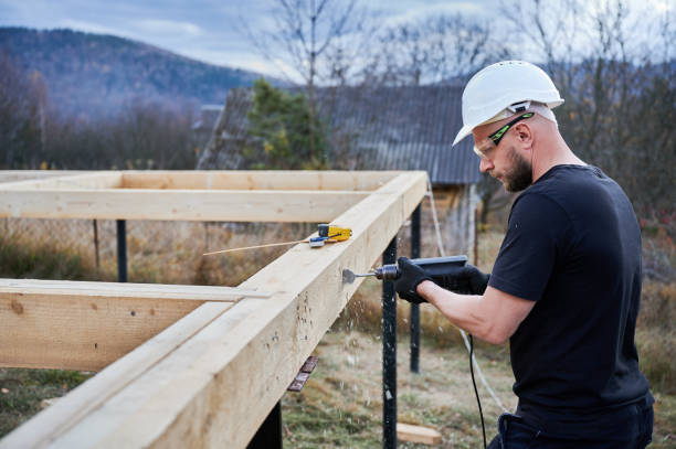 istock Man worker building wooden frame house on pile foundation. 1393556121