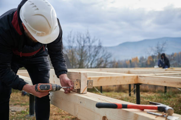 istock Man worker building wooden frame house on pile foundation. 1393556417