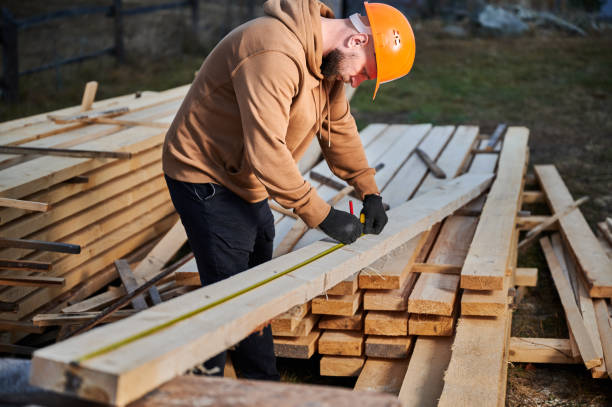 istock Man worker building wooden frame house on pile foundation. 1393556487