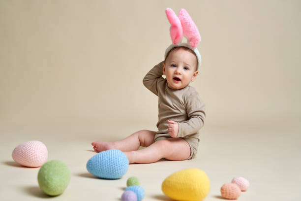 istock Cute little baby wearing bunny's ear  with Easter decorations 1393556498