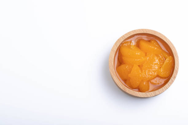 istock Pickled peeled oranges in syrup in a cup.on a white background. 1393557445