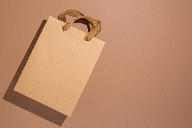 istock One package of gift craft brown on brown craft background. Top view, flat lay 1393557849