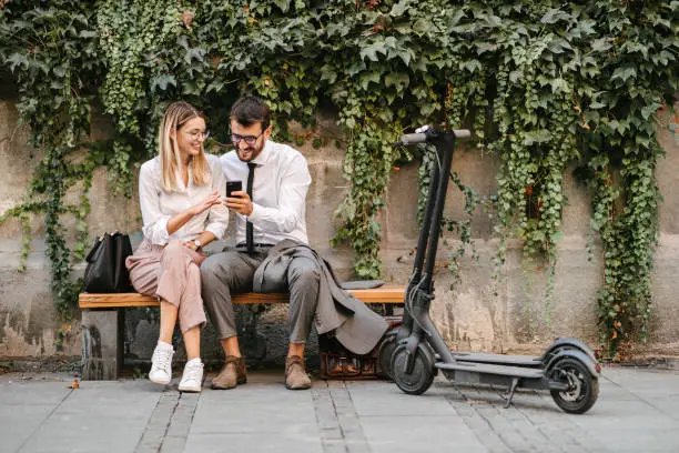 Photo of Business people sitting on a bench