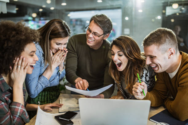istock Cheerful creative team celebrating their success in the office. 1393561481