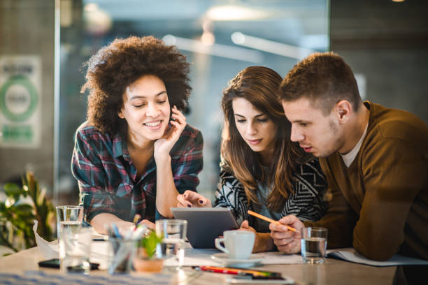 istock Team of young freelancers using digital tablet in the office. 1393565106