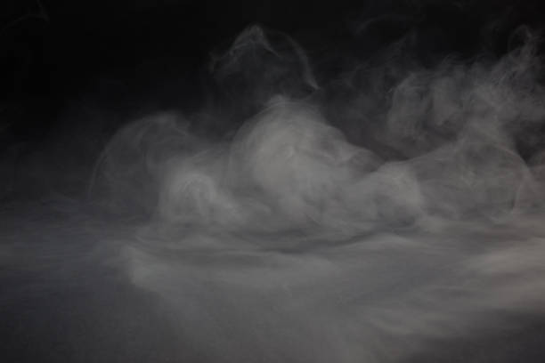 istock Cloud of white smoke on a black background closeup 1393565252