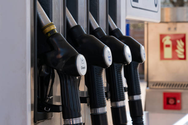 istock A gas pump nozzles at a gas station. 1393565314