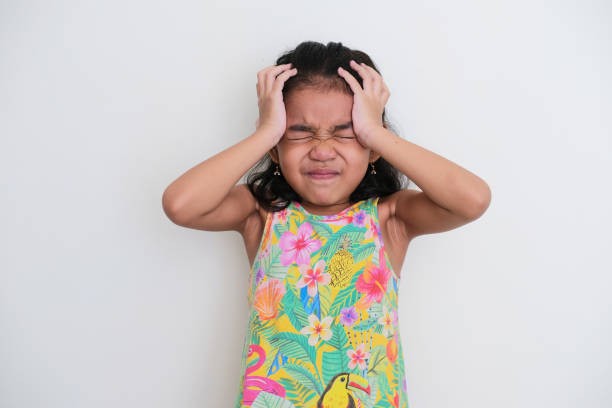Asian kid girl showing stressed expression with both hand on her head Asian kid girl showing stressed expression with both hand on her head keluarga stock pictures, royalty-free photos & images