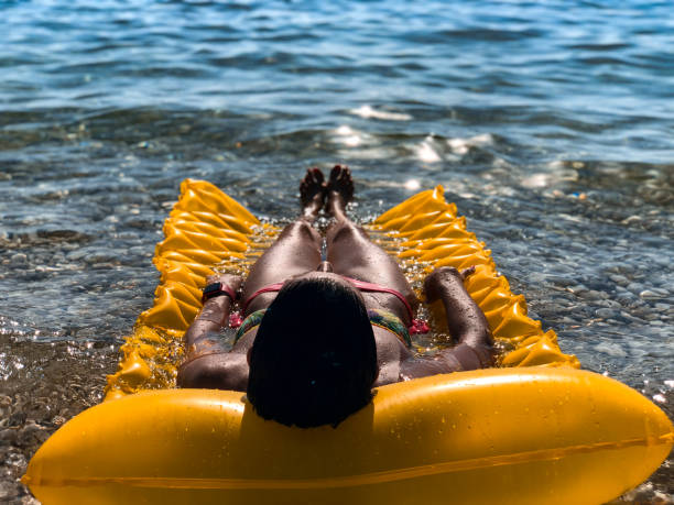 Relaxing and sunbathing on inflatable mattress