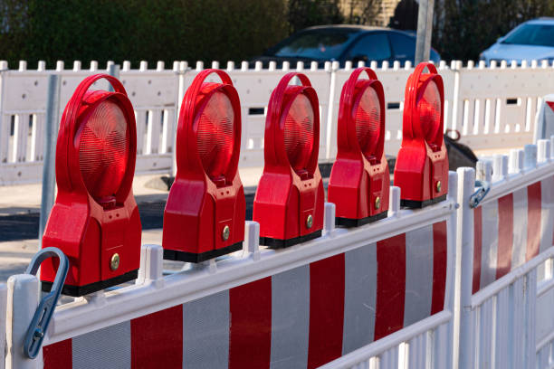 istock Construction barrier at a road with red reflecting lamps as safety installation. 1393566066