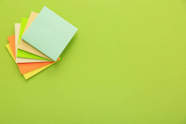 istock Stack of colorful stickers on light green background, top view. Space for text 1393566948