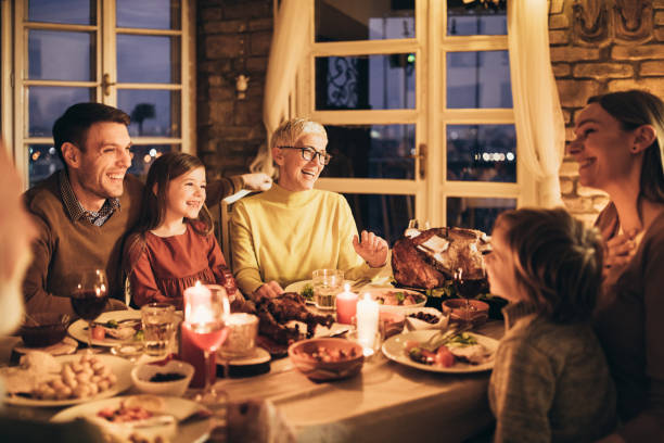 istock Cheerful multi-generation family talking during Thanksgiving dinner at home. 1393567146
