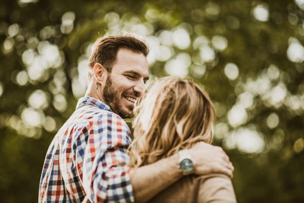 istock Happy couple enjoying while walking embraced in nature. 1393568850