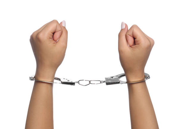istock Woman in handcuffs on white background, closeup 1393568880