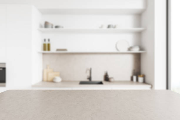 istock Grey countertop on background of kitchen interior with window. Mockup 1393568964