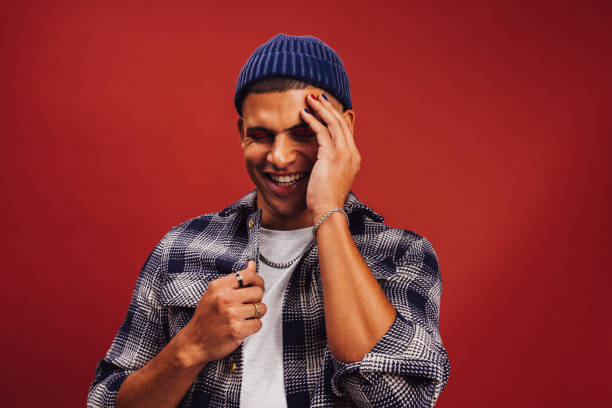istock Young man with a beanie standing in a studio 1393573045